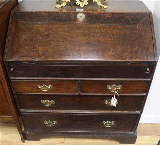 An early Georgian oak bureau, fitted fall front and five drawers, on bracket feet, W.87cm